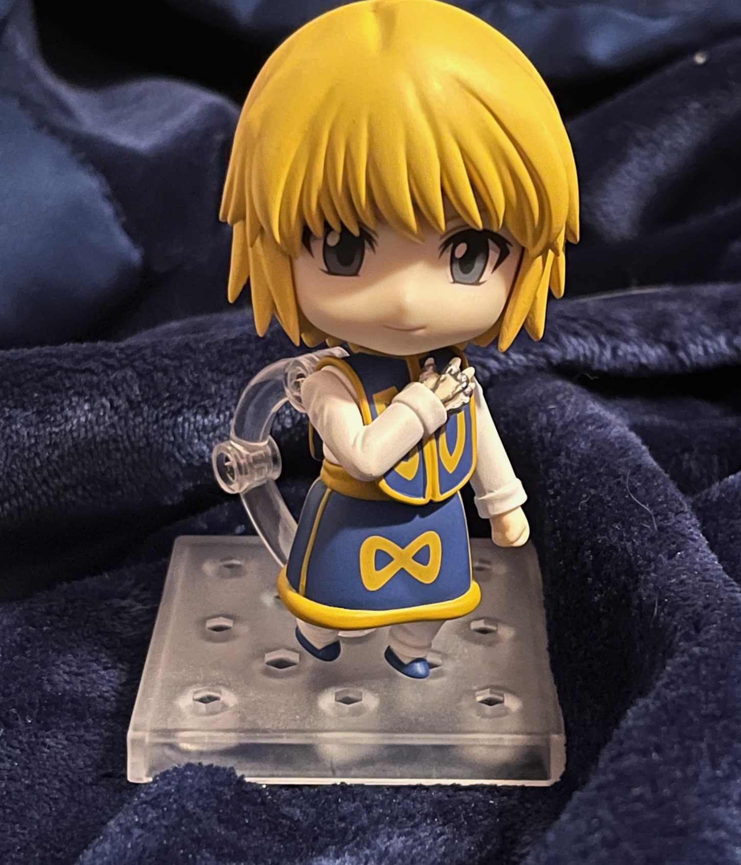 my beloved kurapika nendoroid with smiling faceplate in front of blue background